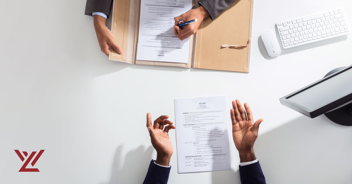 Overhead view of two people reviewing documents across from one another