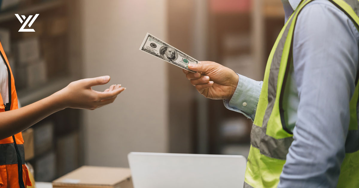 Manager handing cash to an employee