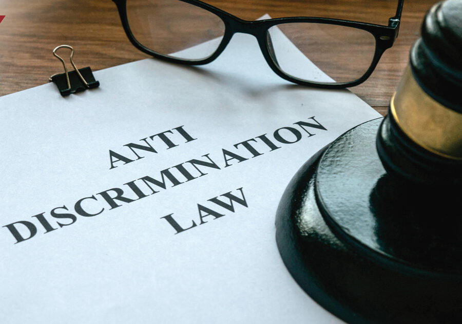 Document reading "Anti Discrimination Law" next to a gavel and glasses
