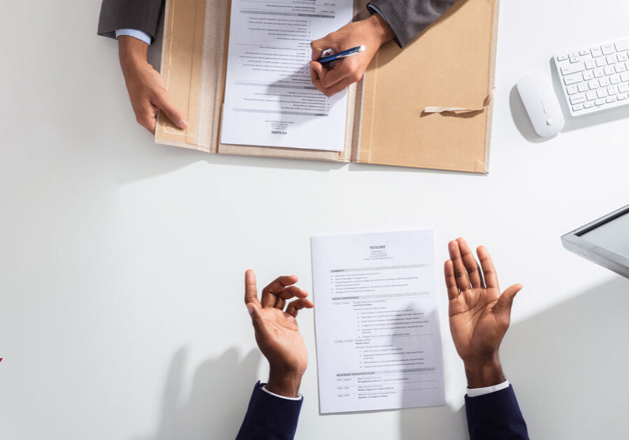 Overhead view of two people reviewing documents across from one another