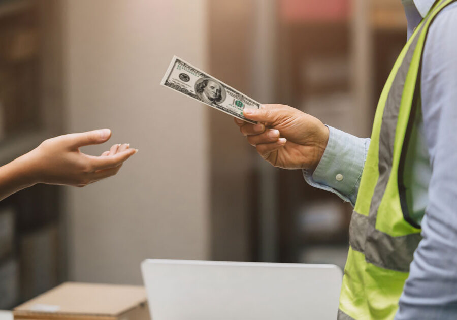 Manager handing cash to an employee